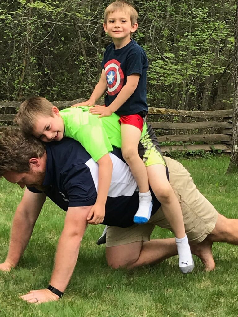 In the backyard of his father’s home in Rhinelander, Wisconsin, David plays with his sons George and Henry in May 2018.